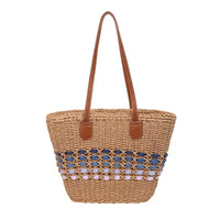 Woven bag with blue and pink bead embellishments on a white background