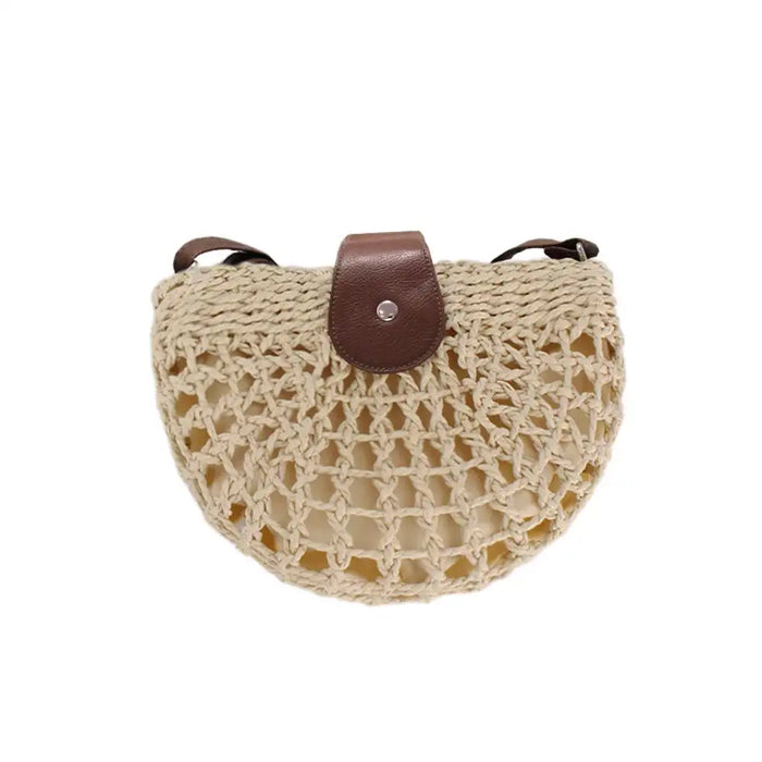 Woven handbag with a brown leather strap on a white background
