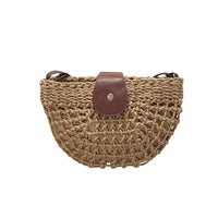 Woven handbag with a brown leather flap on a white background