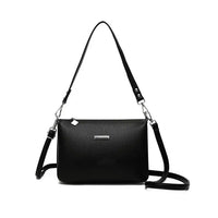 Black handbag with a strap on a white background