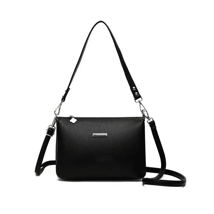 Black handbag with a strap on a white background
