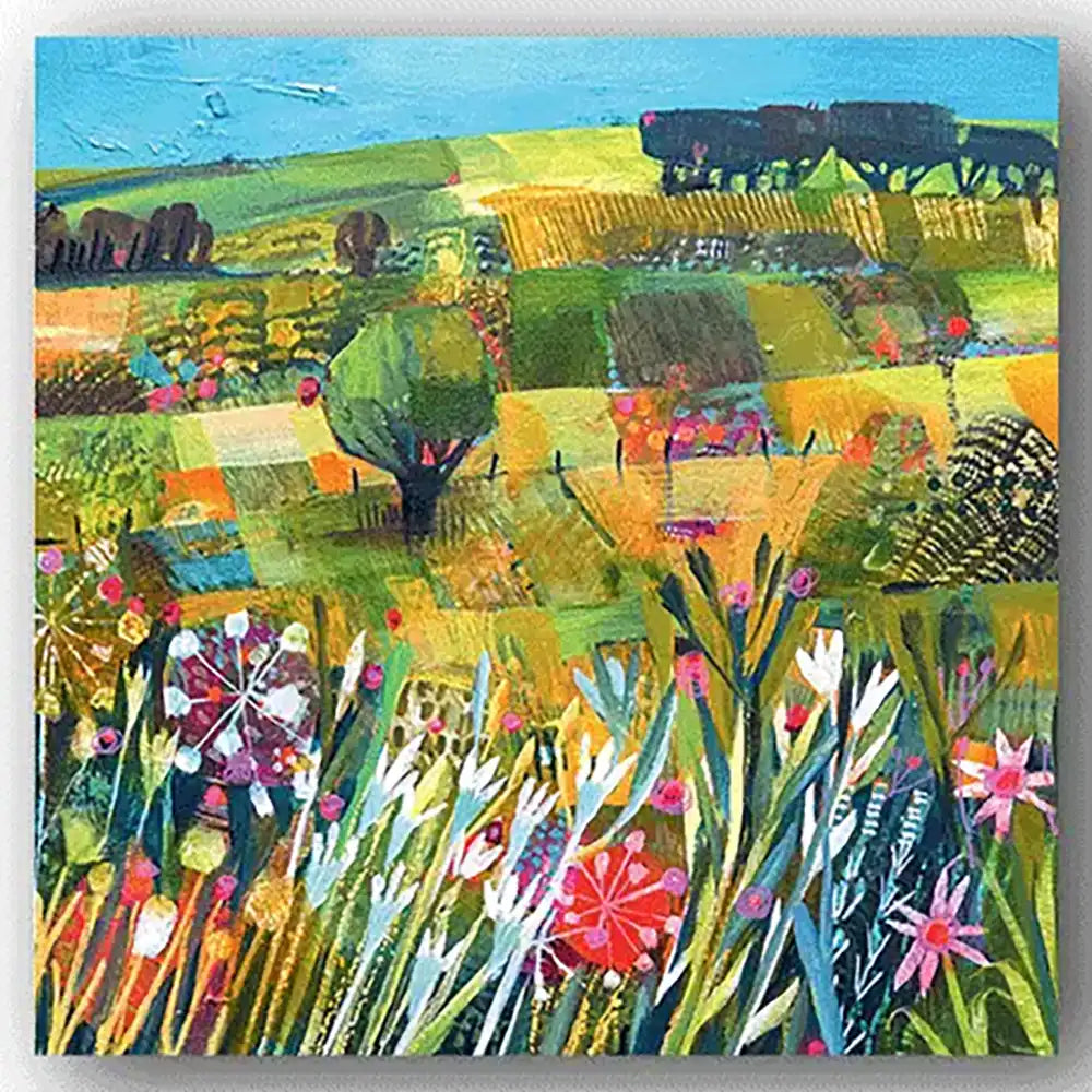 Greetings card with colorful landscape painting with fields, trees, and flowers.