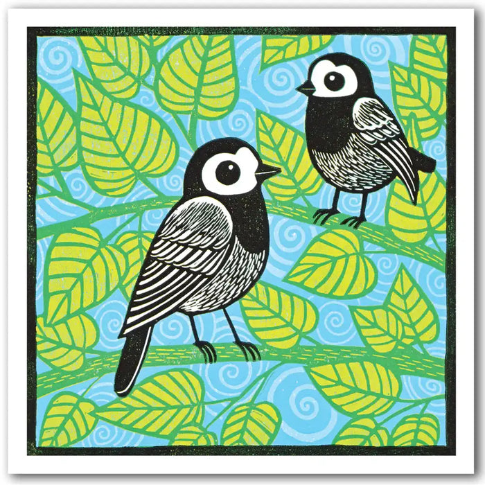 Two black and white birds on a blue background with green leaf pattern