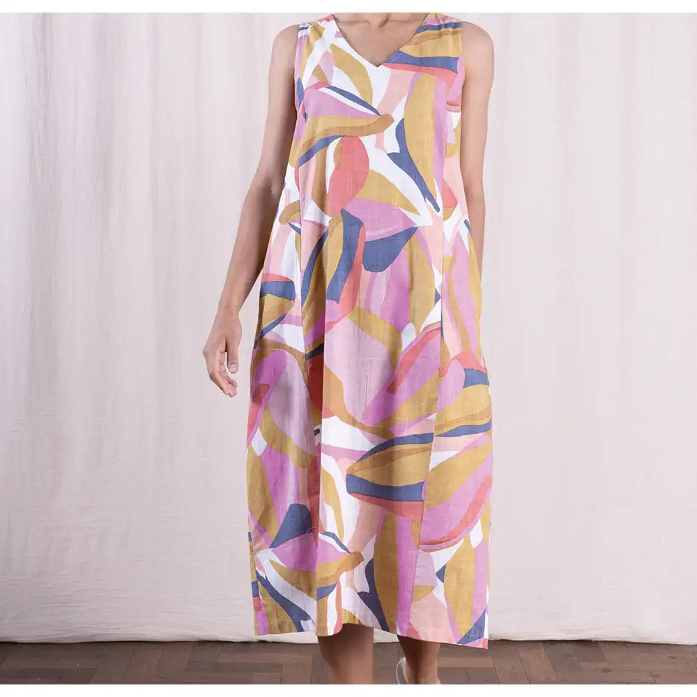 Woman wearing a colorful abstract patterned dress against a white background