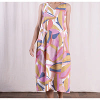 Woman wearing a colorful abstract patterned dress against a white background