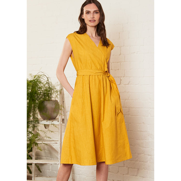 Nomads light mustard A line wrap over dress with belt at the waist. Front view.