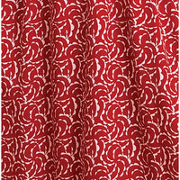 Red curtain fabric with a repeating white floral or scallop pattern, shown hanging with soft folds.