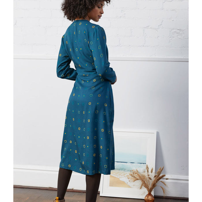 Nomads dark teal wrap over belted dress. Midi length. Evenly spaced circles pattern. Back view.