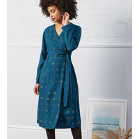 Nomads dark teal wrap over belted dress. Midi length. Evenly spaced circles pattern. Front view.