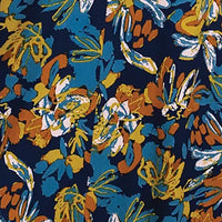 A close-up of a fabric pattern featuring abstract floral and leaf motifs in blue, orange, yellow, and white on a dark navy background.