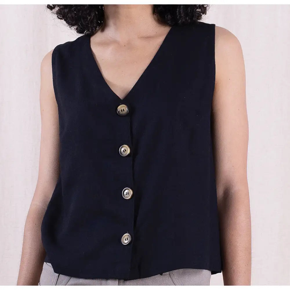 Black sleeveless top with buttons on a plain background