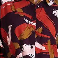 A close-up of a button-up shirt featuring an abstract brushstroke pattern in red, mustard yellow, white, and black.