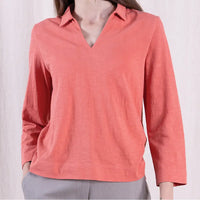 Coral long-sleeve shirt worn by a person on a white background