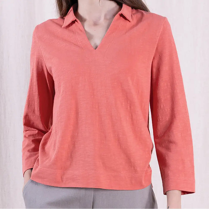 Coral long-sleeve shirt worn by a person on a white background