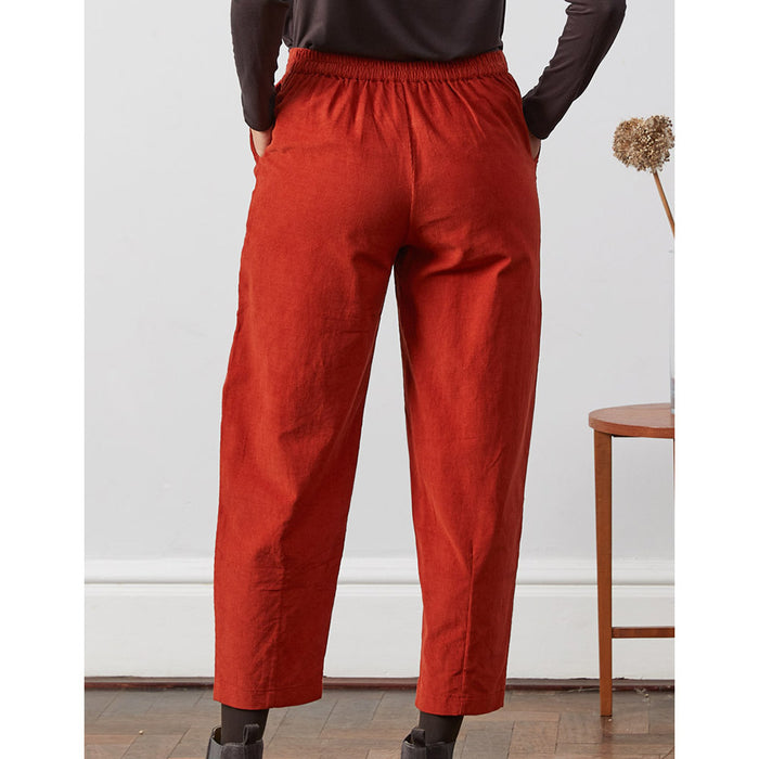 Nomads curved leg cropped trousers in red. Elasticated back. Back view.