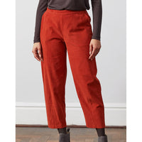 Nomads curved leg cropped trousers in red. Front view.