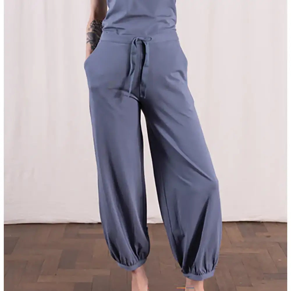 Blue wide-leg pants worn by a person on a plain background