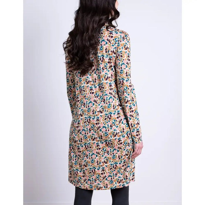 Woman wearing a floral dress with a plain background