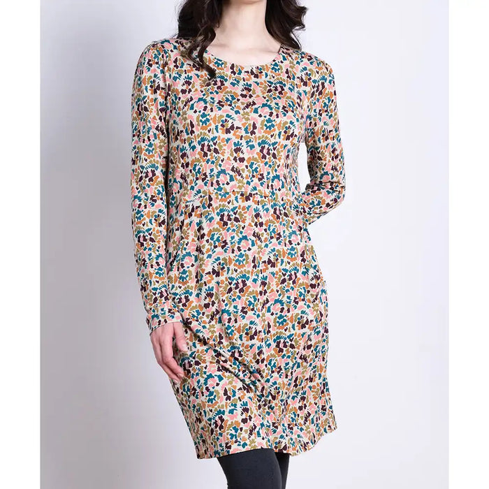 Floral patterned dress worn by a person on a plain background