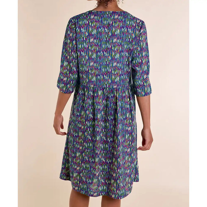 Back of blue dress with white, purple and green stripes. Three quarter sleeves. Falls to the knee. 