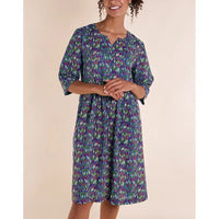 Front of blue dress with white, purple and green stripes. V notch necline. Three quarter sleeves. Falls to the knee. 