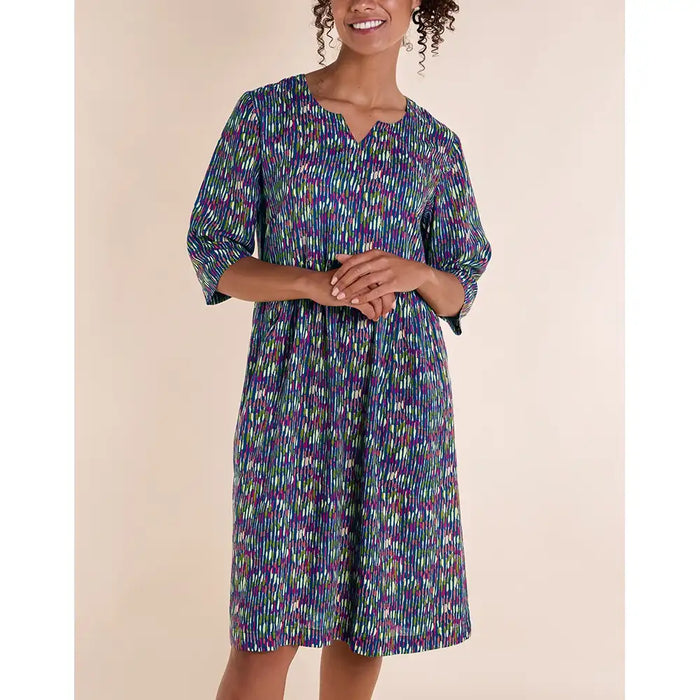 Front of blue dress with white, purple and green stripes. V notch necline. Three quarter sleeves. Falls to the knee. 