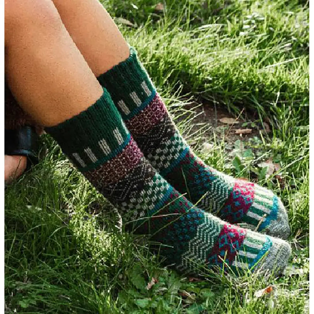 Colorful patterned socks worn outdoors on a grassy surface