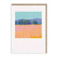 Greeting card with abstract landscape design featuring pink and purple fields and trees on a blue sky background.