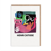 A white greeting card with a kraft envelope behind it, featuring an abstract colorful illustration of a pink cat and the text 'HENRI CATISSE' below the artwork.