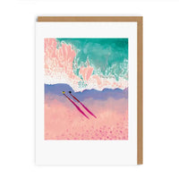 A vertical art print or greeting card with a white border, featuring an abstract beach scene in pink, teal, purple, and peach tones, shown with a brown kraft envelope on a white background.