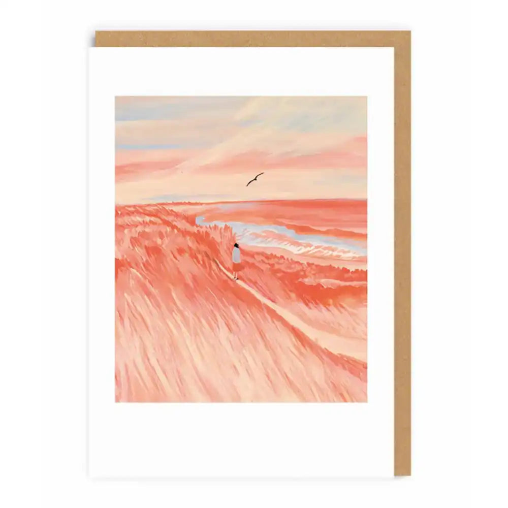 Framed artwork of a desert landscape with a winding road and a person, set against a pink and orange sky.