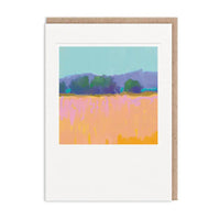 A white greeting card with a kraft brown envelope behind it, featuring a colorful abstract landscape painting of a field and trees.