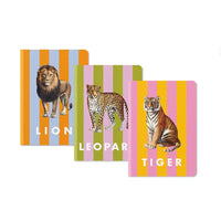 Three notebooks with animal illustrations on colorful striped backgrounds