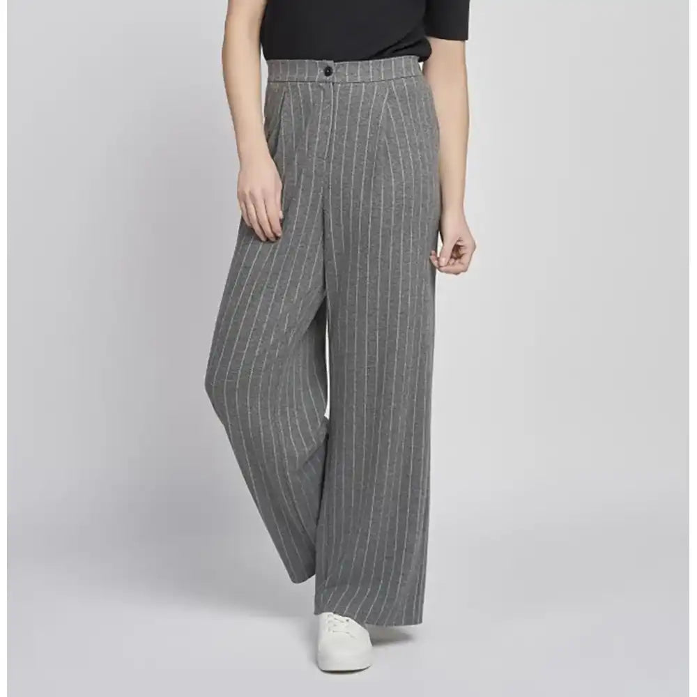 Person wearing gray pinstripe pants on a plain background