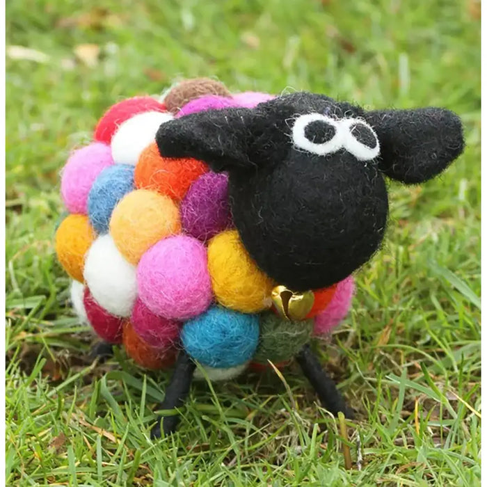Felt sheep with black face and large white eyes. Golden bell under chin. Body made up of multi coloured bobbles. 
