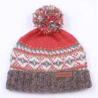 A multicolor knit beanie hat featuring a coral red top section, a white and pink Fair Isle patterned middle section, and a ribbed brown cuff with a small brown leather patch. It is topped with a matching multicolor pom-pom.