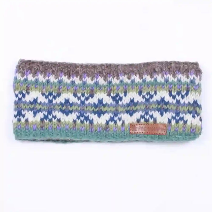 A knitted headband with a multicolor Fair Isle pattern of blue, green, purple, and white, featuring a brown textured top band and a small brown leather brand patch.