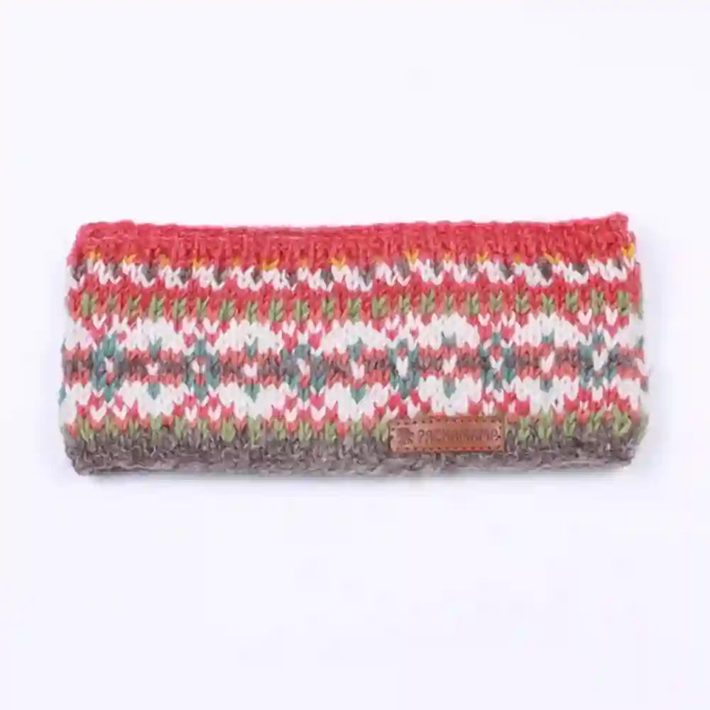 A knitted headband with a multicolor Fair Isle pattern of red, green, gray, and white, featuring a small brown leather brand patch on the front.