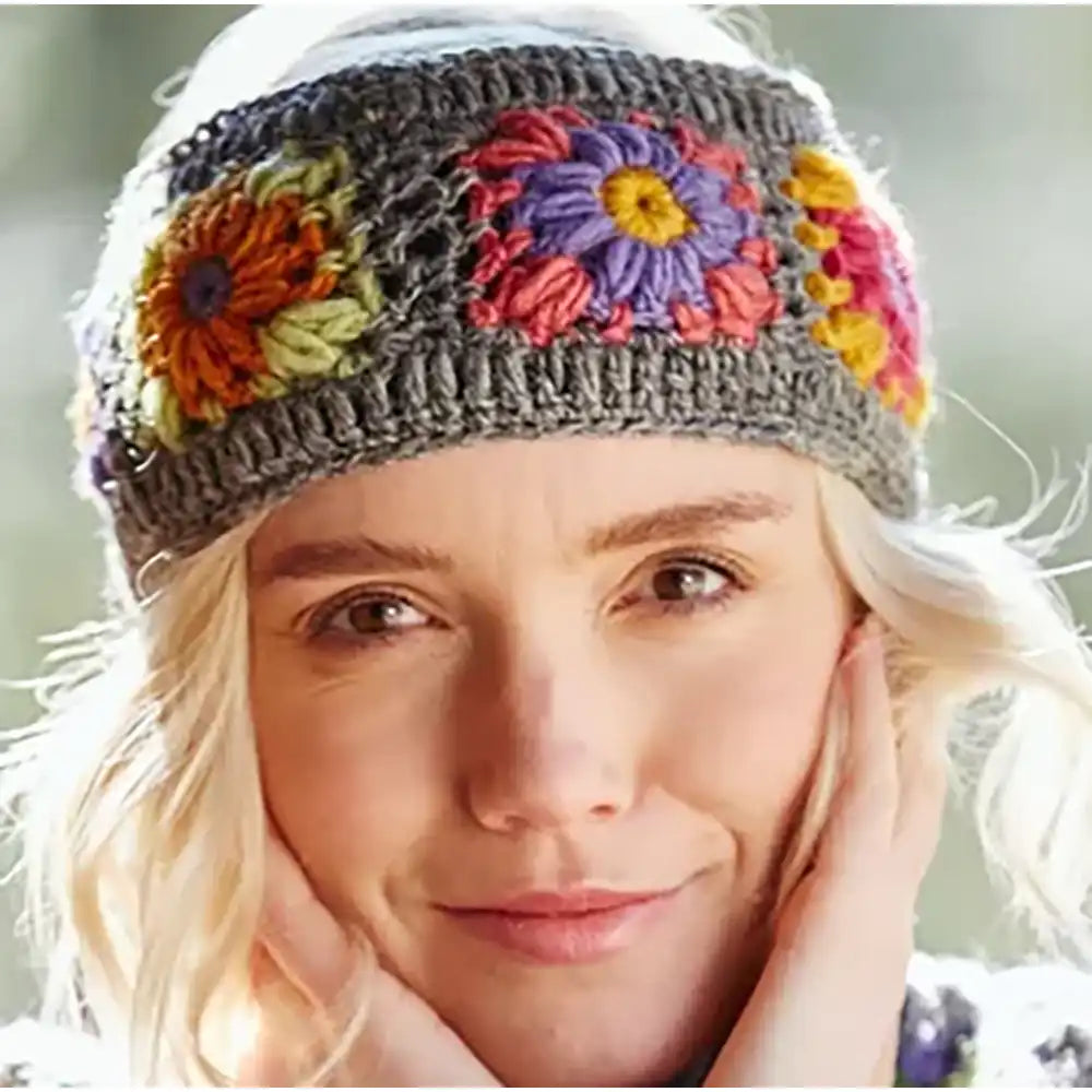 Woman wearing a colorful flower-patterned headband with a blurred natural background