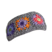 Gray knitted headband with colorful flower patterns on a white background