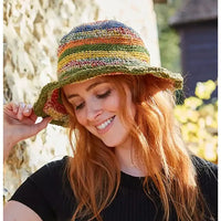 Model wearing a crochet striped hat. Hat is multi coloured.
