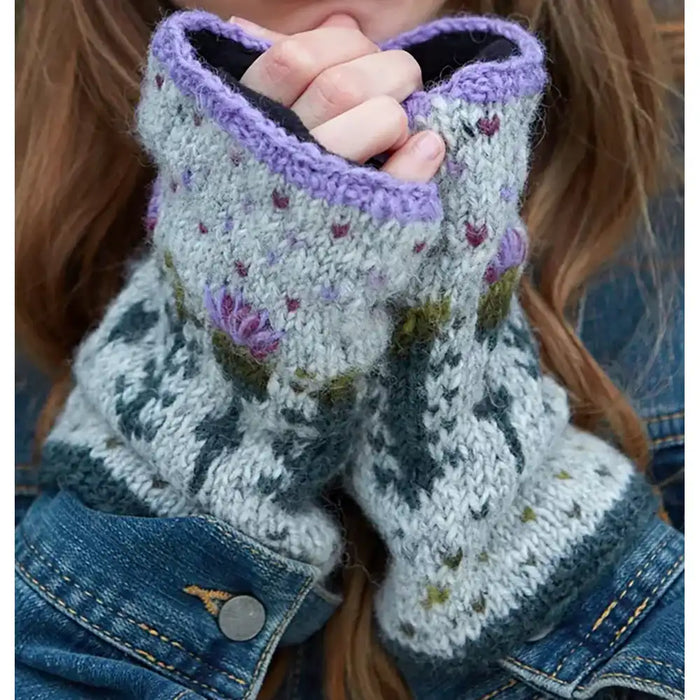A pair of gray, purple, and green thistle-patterned woolen handwarmers with fleece lining at the wrists.