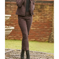 Person wearing a brown dogtooth print trousers with a black contrast. 