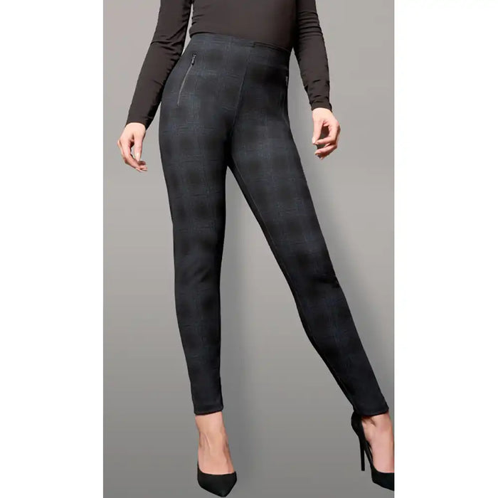 Black leggings worn by a person on a gray background