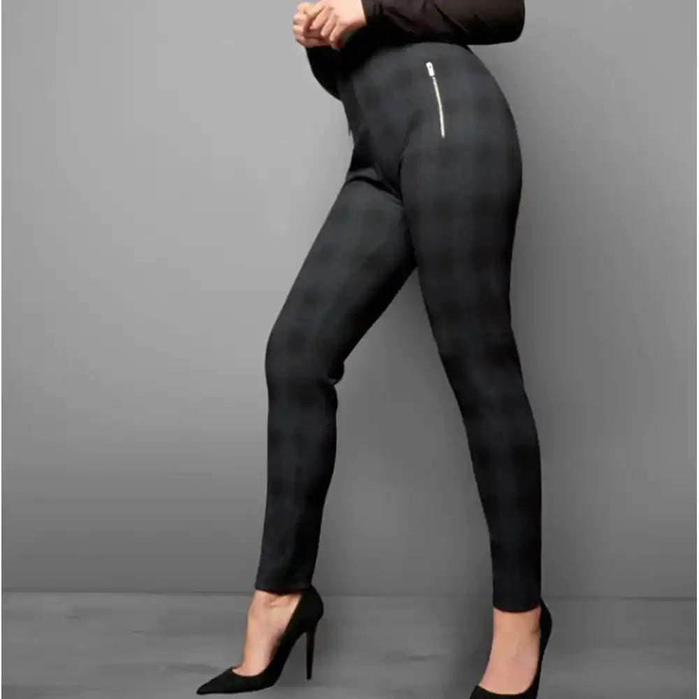 Black leggings worn by a person on a gray background