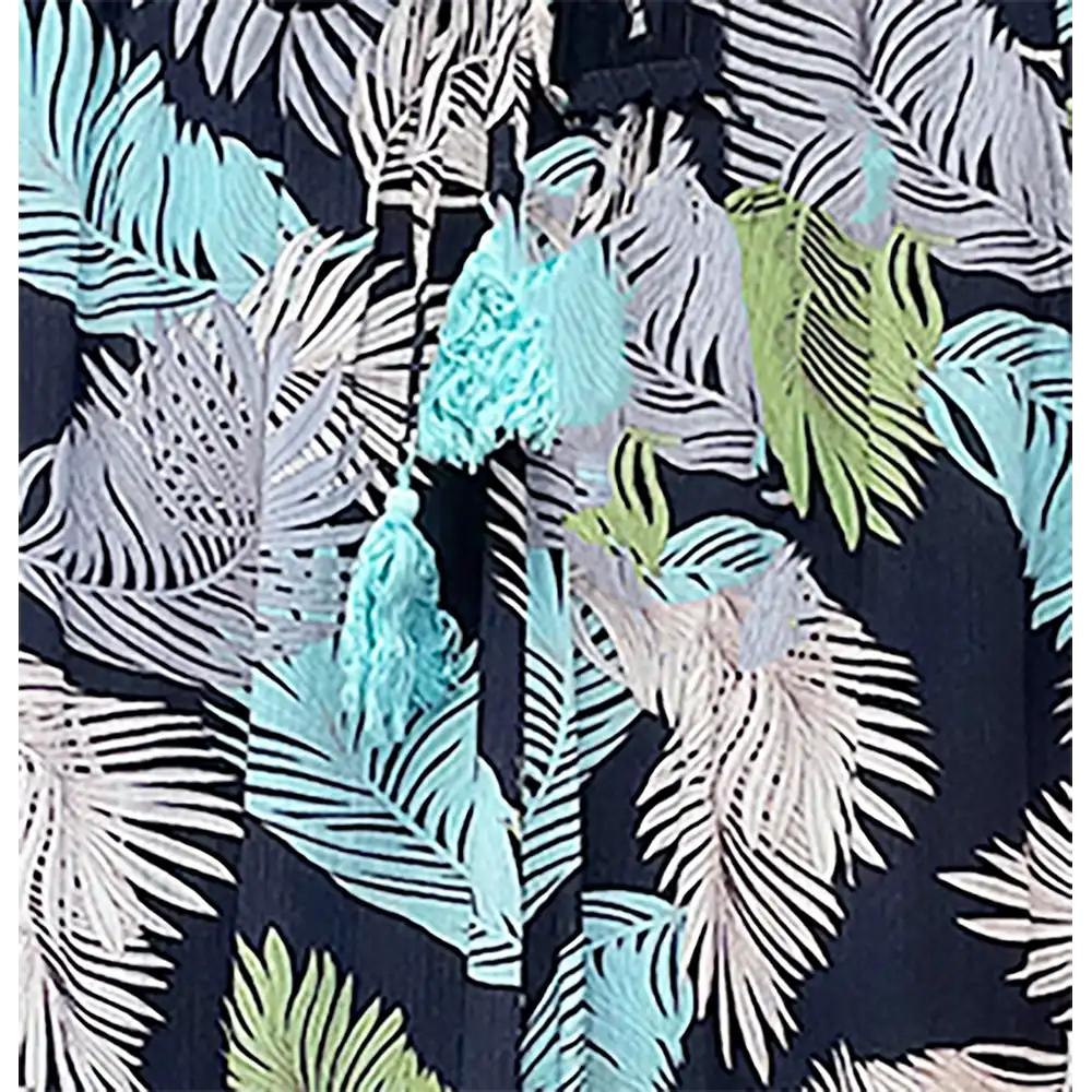 Hawaiian shirt with tropical leaf pattern and tassels on a dark background