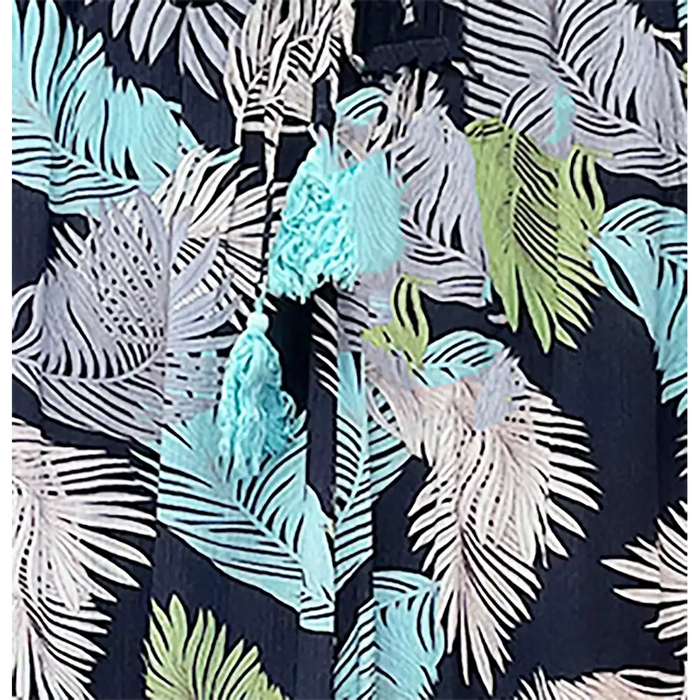 Hawaiian shirt with tropical leaf pattern and tassels on a dark background