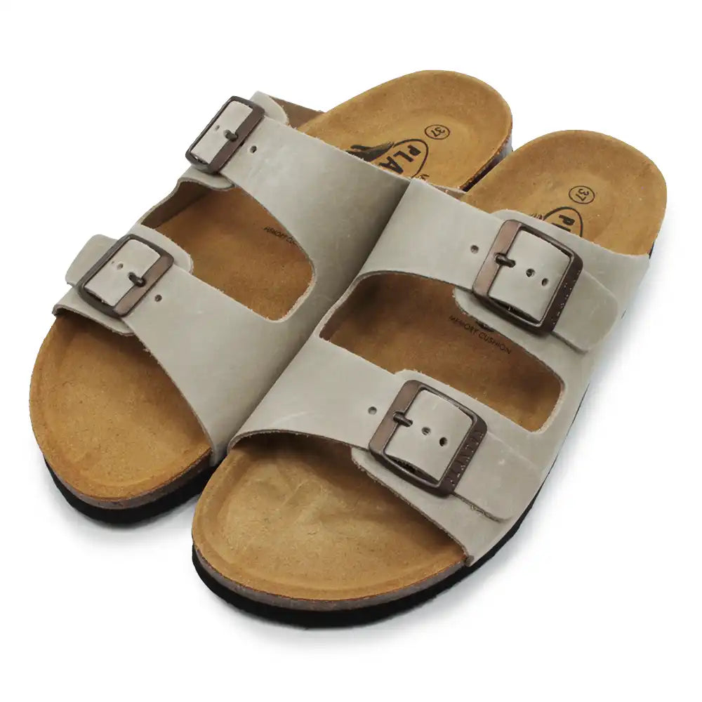 Pair of beige sandals with brown buckles on a white background