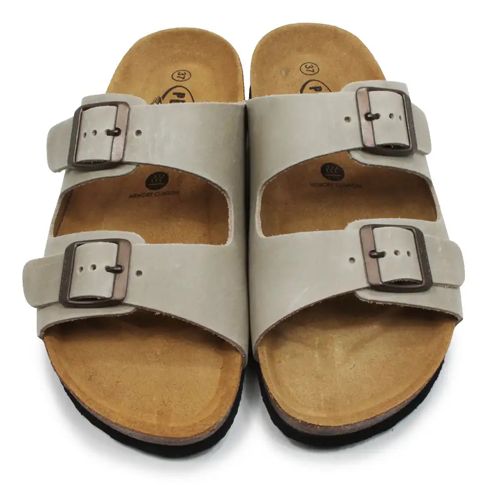 Pair of beige sandals with buckles on a white background