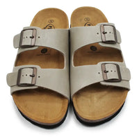 Pair of beige sandals with buckles on a white background